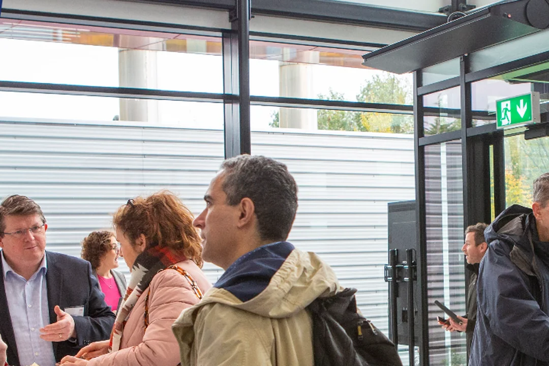 IRDG members talking over coffee in the glass-walled atrium at Logitech's Cork site.